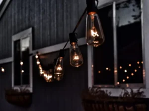 Warm hanging string lights creating cozy outdoor patio lighting at night