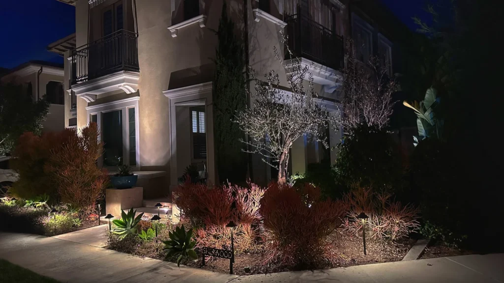 Luxury home exterior architectural lighting with pathway and garden uplighting at night