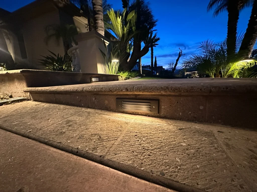 Recessed step light in stone staircase at dusk